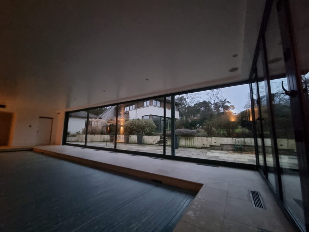 Recently, we tackled a project in Oxford, where the impressive sliding doors to a pool house had developed operational issues due to a dropped head, resulting in jamming and difficult use.